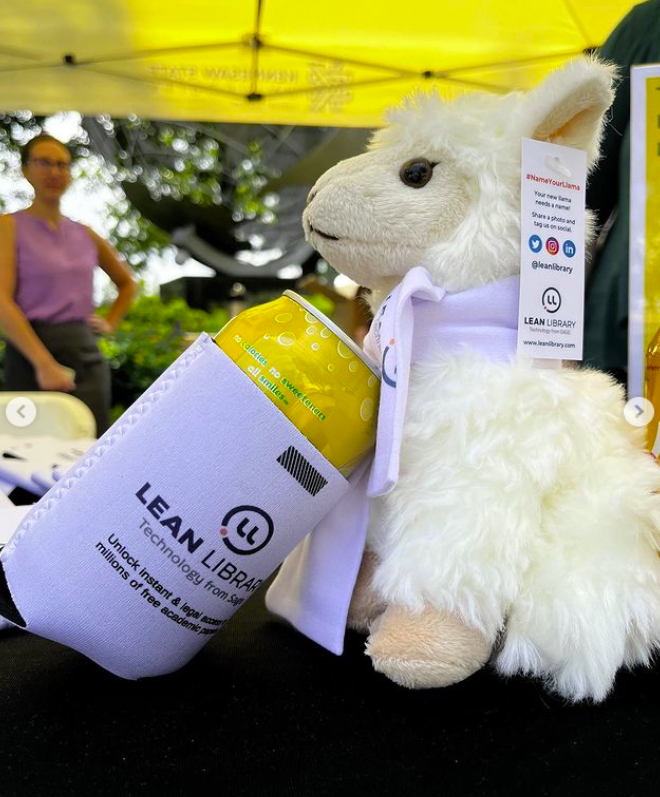 Stuffed llama toy pretending to drink from a can