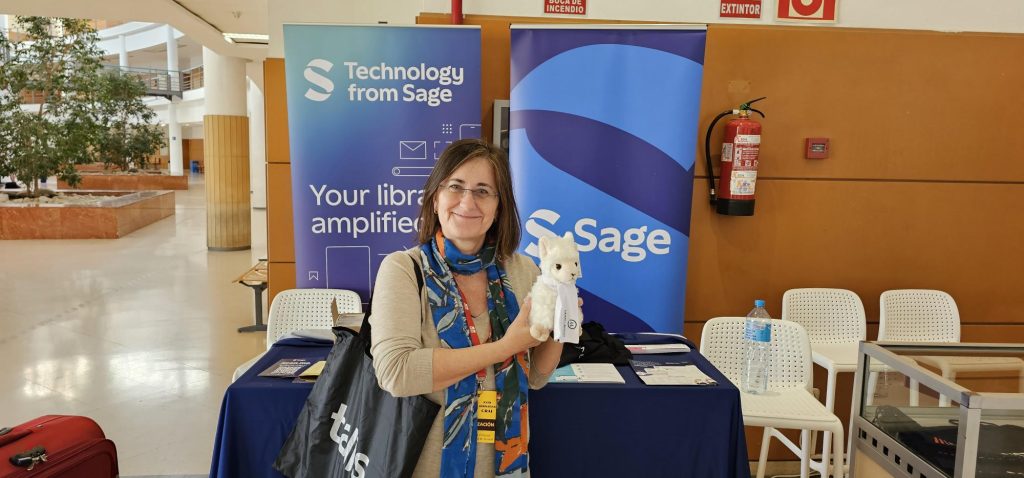 Lean Library Llama being held by Juana at the Lean Library stand at REBIUN Assamblea