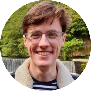 Man with brown hair and glasses smiling