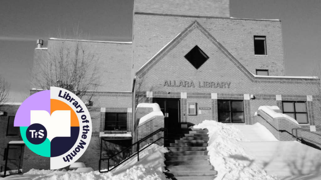 Black and white photo of inside of a library with Library of the Month logo